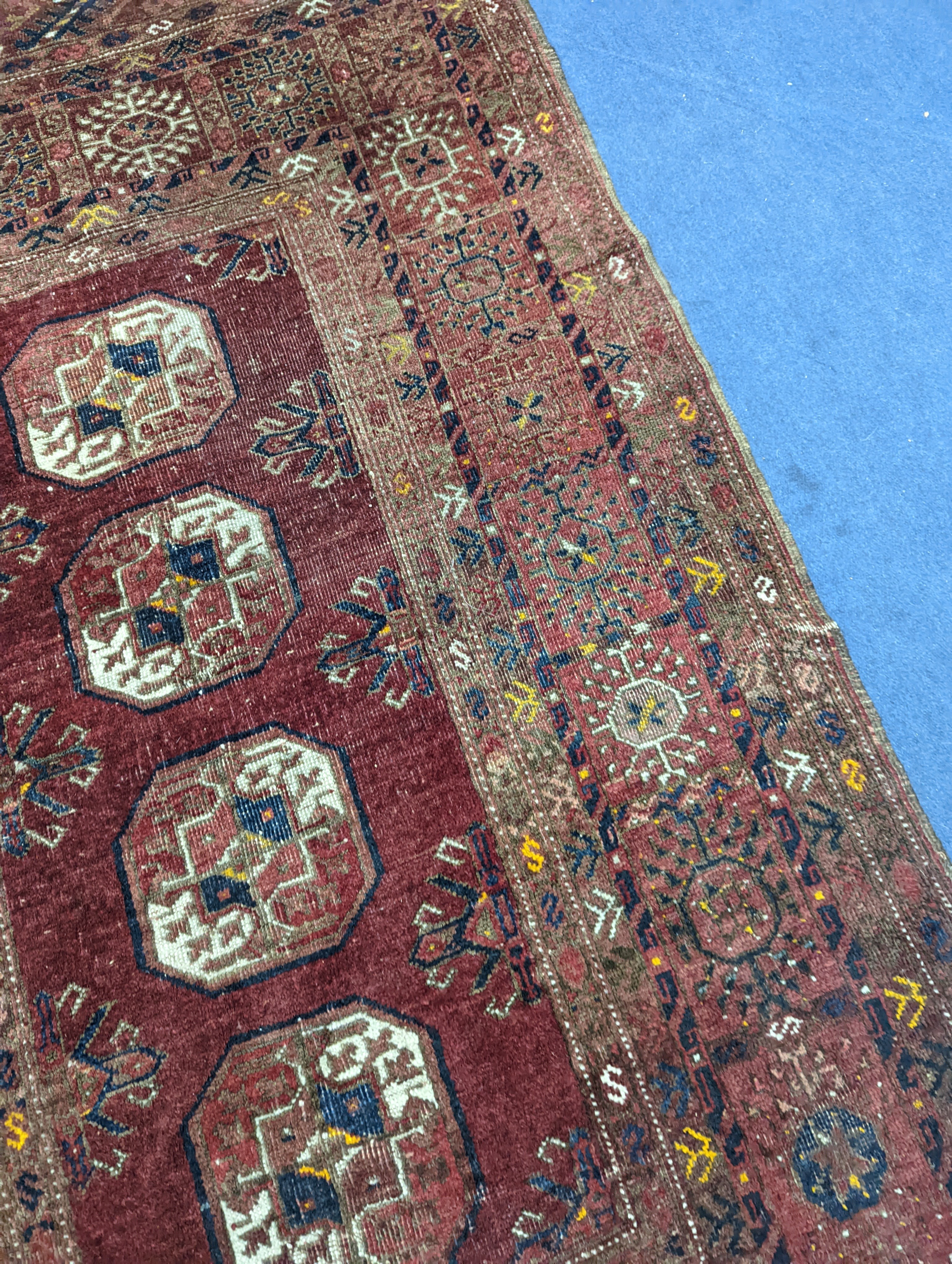 A Bokhara red ground rug, 200 x 114cm